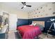 bedroom featuring a ceiling fan, beige walls and blue accent wall with super hero decals at 3377 Park Pointe Cir, Scottdale, GA 30079