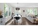 Charming dining room area with modern lighting adjacent to a bright living space at 3377 Park Pointe Cir, Scottdale, GA 30079