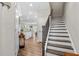 Welcoming entryway features wood-look floors, staircase, and a glimpse into the bright, open kitchen at 3377 Park Pointe Cir, Scottdale, GA 30079
