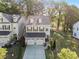 Aerial view of a two story home with a two car garage and a green lawn at 3377 Park Pointe Cir, Scottdale, GA 30079