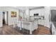 Well-lit kitchen featuring a large island with seating, granite countertops, and stainless steel appliances at 3377 Park Pointe Cir, Scottdale, GA 30079