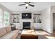 Open-concept living room with a fireplace and built-in bookcases at 3377 Park Pointe Cir, Scottdale, GA 30079
