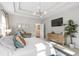 Bright main bedroom features a tray ceiling, modern light fixture, tv, and hardwood dresser at 3377 Park Pointe Cir, Scottdale, GA 30079