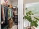 Spacious walk-in closet with storage and shelving, next to a soaking tub with a window at 3377 Park Pointe Cir, Scottdale, GA 30079