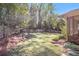Well-manicured backyard featuring a lush lawn, mature trees, and a privacy fence at 504 Baltimore Sw Ave, Lilburn, GA 30047