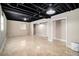 Finished basement featuring a large, open space with tiled floors and exposed ceiling at 504 Baltimore Sw Ave, Lilburn, GA 30047