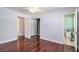 This bedroom boasts hardwood floors, a ceiling fan, and a mirrored closet with an ensuite bath at 504 Baltimore Sw Ave, Lilburn, GA 30047