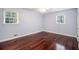 Bedroom with wood floors, ceiling fan, and windows with blinds at 504 Baltimore Sw Ave, Lilburn, GA 30047