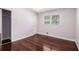 Bedroom with wood floors, closet, and window with blinds at 504 Baltimore Sw Ave, Lilburn, GA 30047