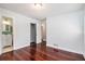 Bright bedroom with hardwood floors, closet, and an ensuite bathroom with a single sink vanity at 504 Baltimore Sw Ave, Lilburn, GA 30047