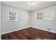 Cozy bedroom with hardwood floors and two large windows providing plenty of natural light at 504 Baltimore Sw Ave, Lilburn, GA 30047