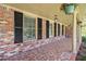 Inviting covered porch with decorative columns, tiled floor, and hanging plants, perfect for relaxing at 504 Baltimore Sw Ave, Lilburn, GA 30047