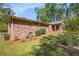 Charming brick home with a screened porch, surrounded by lush landscaping and a well-maintained lawn at 504 Baltimore Sw Ave, Lilburn, GA 30047