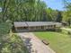 Expansive one-story brick home with mature trees, a long driveway, and well-maintained landscaping at 504 Baltimore Sw Ave, Lilburn, GA 30047