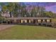 Charming one-story brick home with a well-manicured lawn, and a covered carport at 504 Baltimore Sw Ave, Lilburn, GA 30047
