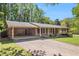 Charming brick home featuring a covered carport and well-maintained landscaping, enhancing its curb appeal at 504 Baltimore Sw Ave, Lilburn, GA 30047