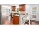 Well-lit kitchen with breakfast bar, wood cabinets, granite countertops, and stainless steel appliances at 504 Baltimore Sw Ave, Lilburn, GA 30047