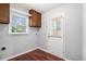Laundry area with wood floors and a window at 504 Baltimore Sw Ave, Lilburn, GA 30047