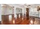 Spacious living room with hardwood floors, featuring an open layout, and access to the kitchen and dining areas at 504 Baltimore Sw Ave, Lilburn, GA 30047