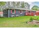 Exterior view of the home showcasing a well-maintained lawn and brick facade at 846 Orris Ln, Mableton, GA 30126