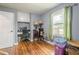 Bedroom with hardwood floors, a window with green curtains, and a built-in desk at 846 Orris Ln, Mableton, GA 30126