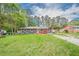 Full front exterior view of a charming house with well-maintained landscaping and carport at 846 Orris Ln, Mableton, GA 30126