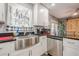 Well-lit kitchen with white cabinetry, stainless steel appliances, a stainless apron sink, and black granite at 846 Orris Ln, Mableton, GA 30126