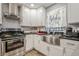 Cozy kitchen featuring stainless steel appliances, apron sink, granite countertops, and white cabinetry at 846 Orris Ln, Mableton, GA 30126