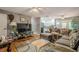 Spacious living room with hardwood floors, a modern sofa, and a view of the kitchen at 846 Orris Ln, Mableton, GA 30126