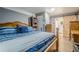 Main bedroom with a wooden bed frame, complemented by soft blue bedding and a barn door leading to the en-suite bathroom at 846 Orris Ln, Mableton, GA 30126
