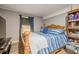 Cozy main bedroom with wood-look floors, soothing color palette, and a large wood bookcase adds style and storage at 846 Orris Ln, Mableton, GA 30126