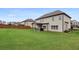 Exterior rear view of the home showing a large grassy backyard and covered patio at 2511 Day Break Way, Dacula, GA 30019