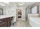 Bright bathroom boasting a soaking tub, glass-enclosed shower, and dual vanity at 2511 Day Break Way, Dacula, GA 30019