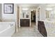 Bright bathroom boasts a soaking tub, tile flooring, and dual vanity at 2511 Day Break Way, Dacula, GA 30019