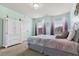 Pastel bedroom with purple-shaded curtains, carpeted floors, and large wardrobe at 2511 Day Break Way, Dacula, GA 30019