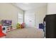 Bright, carpeted bedroom features natural light, play area, and neutral walls at 2511 Day Break Way, Dacula, GA 30019