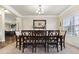 Traditional dining room with a large window and decorative chandelier with seating for eight at 2511 Day Break Way, Dacula, GA 30019