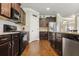 Well-equipped kitchen featuring dark wood cabinets, stainless steel appliances, and ample countertop space at 2511 Day Break Way, Dacula, GA 30019