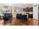 Eat-in kitchen featuring dark wood cabinets, stainless steel appliances and a center island with seating at 2511 Day Break Way, Dacula, GA 30019