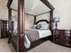 Opulent main bedroom featuring a canopy bed, carpeted floors, and traditional decor at 2511 Day Break Way, Dacula, GA 30019