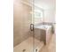 Modern bathroom featuring a glass shower, soaking tub, and stylish gray tiling at 2626 Radvell Ct, Decatur, GA 30034