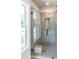 Contemporary bathroom with a glass-enclosed shower, neutral tiles, and a window at 2626 Radvell Ct, Decatur, GA 30034