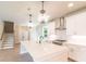 Open kitchen boasts a spacious island, stainless hood, and elegant pendant lighting at 2626 Radvell Ct, Decatur, GA 30034