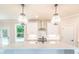 Well-appointed kitchen featuring white cabinets, quartz countertops, and pendant lighting at 2626 Radvell Ct, Decatur, GA 30034
