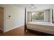 Bright bedroom with a four-poster bed, wood floors, and large window with natural light at 2637 Peachtree Ne Rd # 407, Atlanta, GA 30305