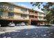Multi-story condo building with covered parking and balconies in a lush, tree-lined neighborhood at 2637 Peachtree Ne Rd # 407, Atlanta, GA 30305