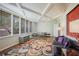 Bright living room with coffered ceiling, large windows, wood floors and colorful area rug at 2637 Peachtree Ne Rd # 407, Atlanta, GA 30305