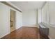 Bright living room featuring wood floors, large windows, and view into the kitchen at 2637 Peachtree Ne Rd # 407, Atlanta, GA 30305