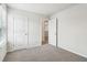 A new bedroom with neutral paint, carpet and trim with a partially open door at 2762 Aralynn Way, College Park, GA 30337