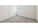 Well-lit bedroom featuring neutral paint, gray carpeting, and trim to enjoy at 2762 Aralynn Way, College Park, GA 30337